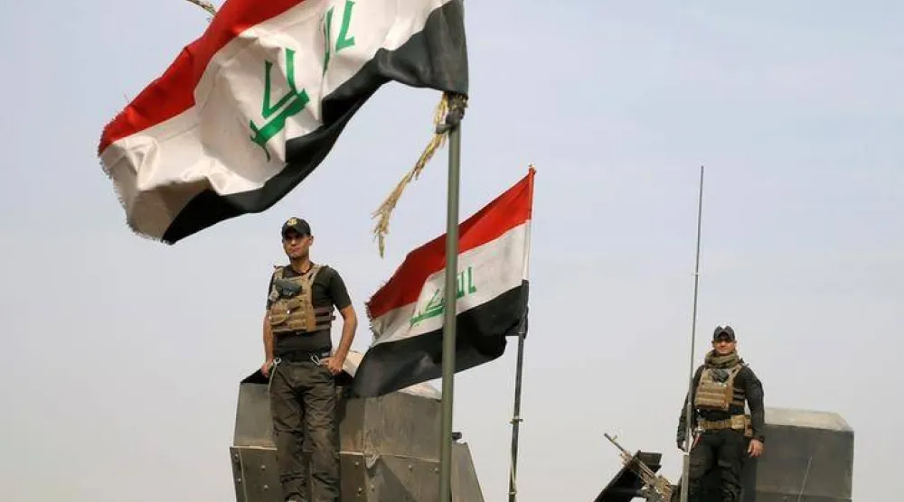 جنود من القوات الخاصة العراقية يقفون فوق مركبات مدرعة في قرية قرب الموصل بالعراق يوم 25 أكتوبر 2016 (رويترز)