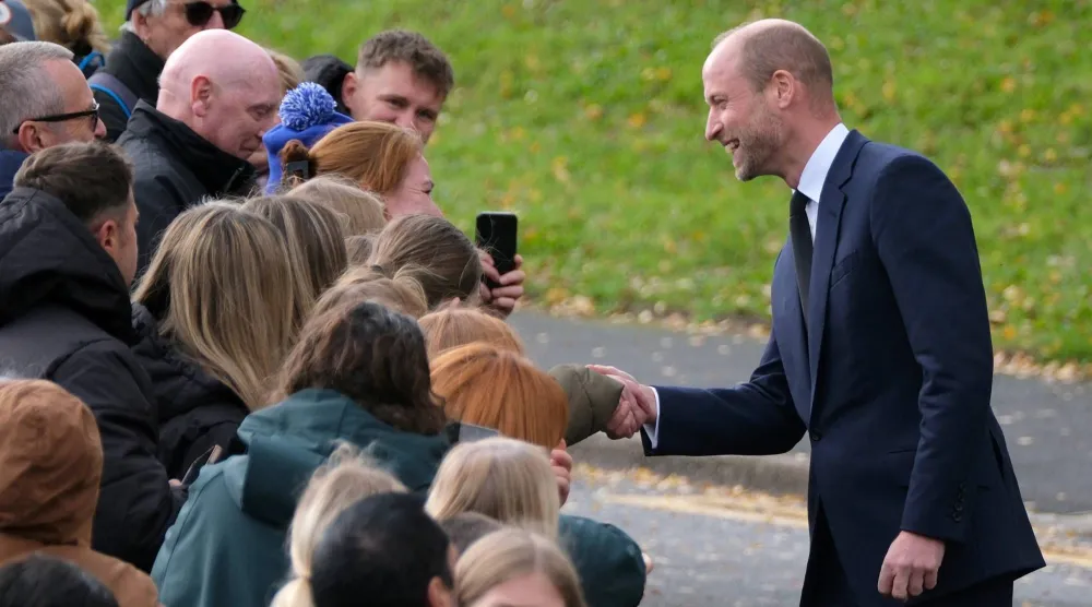 Britain's Prince William meets with the public on a street during a royal visit to the Aberfan Disaster Memorial Garden to mark the 60th anniversary of the 1966 disaster, in which 109 children and five teachers were killed at Pantglas Junior School when a coal spoil tip collapsed onto the Welsh village, Britain, October 21, 2026. (Reuters)