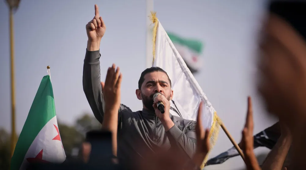 متظاهر يستخدم ميكروفوناً خلال مظاهرة في درعا ضد التوغلات الإسرائيلية في الأراضي السورية (أ.ب)