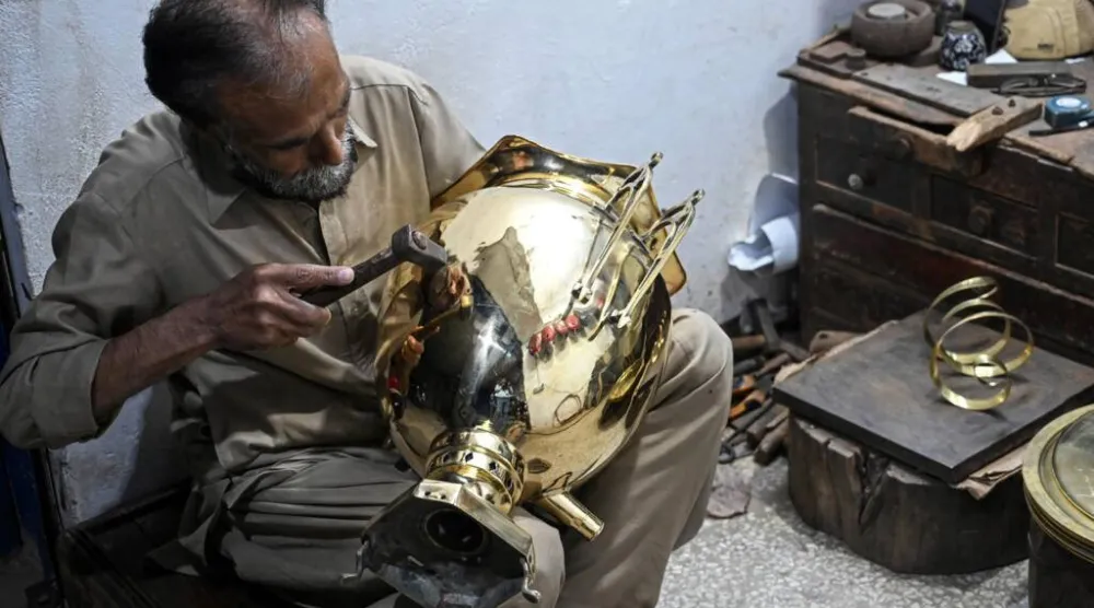 Restorer Shakeel Ahmed works on an antique at his workshop in Rawalpindi. Farooq NAEEM / AFP
