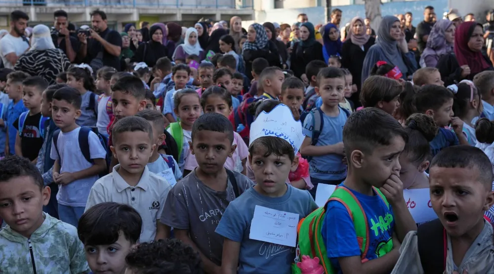 أطفال فلسطينيون يصطفون في اليوم الأول من العام الدراسي الجديد في مدرسة تديرها الأمم المتحدة في النصيرات وسط قطاع غزة يوم 19 سبتمبر 2026 (أ.ب)