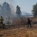 رجال الإطفاء الإسرائيلي يعملون على السيطرة على النيران في أعقاب الهجمات الصاروخية من لبنان (رويترز)