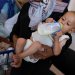طفل فلسطيني عمره 8 شهور يتناول الحليب في مستشفى الرنتيسي في مدينة غزة (رويترز) 