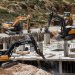 آليات إسرائيلية ثقيلة تهدم مبنى فلسطينياً قرب بيت لحم في الضفة الغربية المحتلة يوم الاثنين (رويترز)