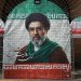 امرأة تسير بجوار لافتة تحمل صورة المرشد الإيراني مجتبى خامنئي في طهران 8 مايو الحالي (رويترز)