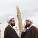 رجلا دين يشاركان في مراسم إحياء ذكرى الثورة بينما يعرض صاروخ باليستي في ميدان آزادي غرب طهران فبراير الماضي (رويترز)
