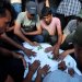 مشيِّعون يحضرون جنازة 3 فلسطينيين بينهم الصبي طارق صباح (10 سنوات) قُتلوا بغارة إسرائيلية في خان يونس جنوب غزة يوم الأربعاء (رويترز)