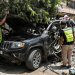 مسعفون وعناصر إنقاذ يعاينون السيارة التي استهدفت بغارة إسرائيلية في النبطية بجنوب لبنان وأدت إلى مقتل 4 أشخاص (أ.ف.ب)