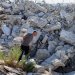 فلسطيني يتفقد الأضرار بعد أن هدمت آليات إسرائيلية مبنى فلسطينياً قرب بيت لحم في الضفة الغربية المحتلة (رويترز)