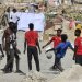 مهاجرون يلعبون بالكرة على شاطئ ترمبولين في سبتة - إسبانيا يوم 18 أغسطس 2026 (إ.ب.أ)