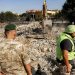 جندي لبناني ومتطوع بالدفاع المدني يشرفان على إزالة الركام بمبنى دمرته غارة إسرائيلية في بلدة كفر رمان جنوب لبنان (أ.ف.ب)