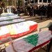 نعوش ملفوفة بالعلم اللبناني خلال تشييع 12 شخصاً قتلوا بغارة إسرائيلية في بلدة كفر رمان بجنوب لبنان الاثنين بينهم مقاتلين اثنين في «حزب الله» (أ.ف.ب)