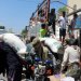 أشخاص ينقلون دقيق القمح من على متن شاحنة في تعز المحاصرة من قبل الحوثيين (رويترز)