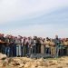مشيعون يصلون على جثامين الضحايا المدنيين في غارات جوية أردنية الليلة السابقة على قرية الطاف في منطقة اللجاة بريف درعا الشمالي الشرق (أ.ف.ب)